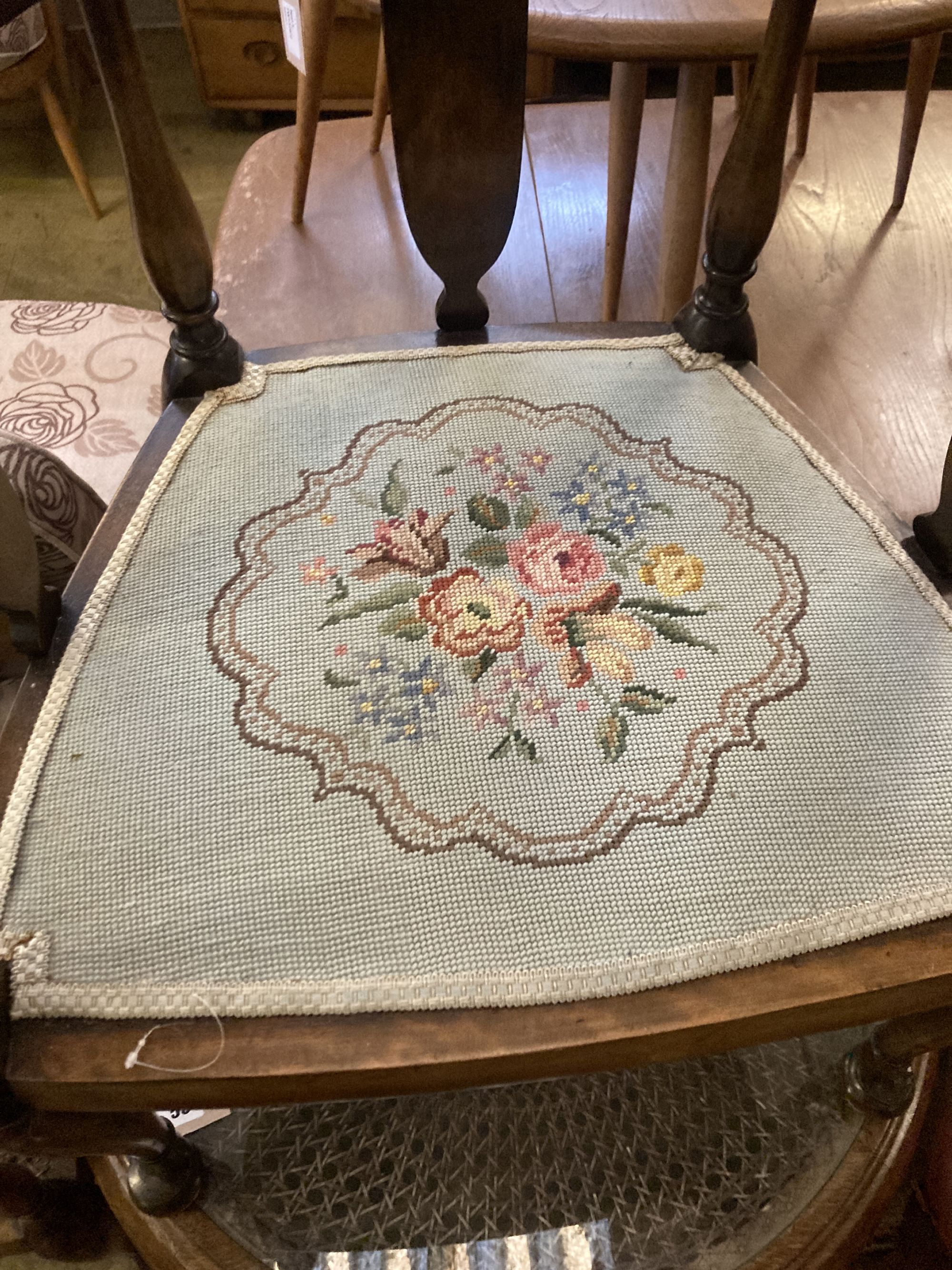 A 1920s circular caned beech occasional table, diameter 76cm, together with a pair of elbow chairs, one with a later tapestry seat